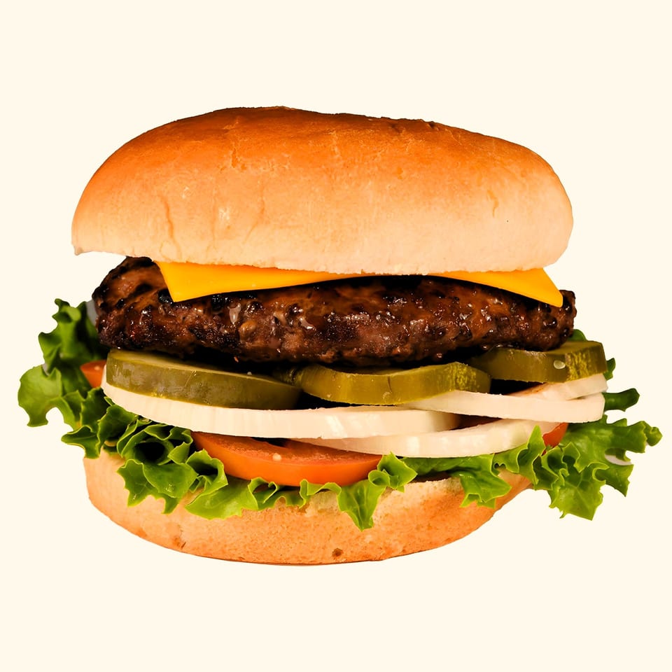 M2 Burger with a beef patty, melted cheese, pickles, onions, tomato, and lettuce on a bun.